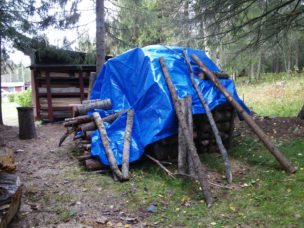 IMGP2170.JPG - Slängde på en presening över stora vedhögen. Tänkte att det är onödigt med snö och is på det man kanske vill klyva redan i vinter.